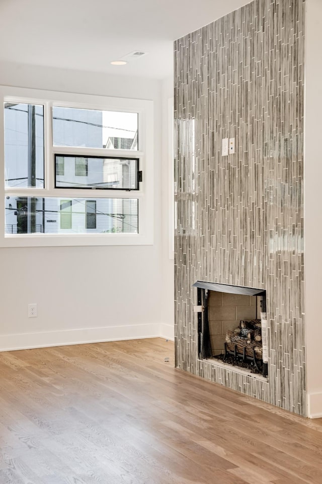 unfurnished living room with hardwood / wood-style floors and a fireplace