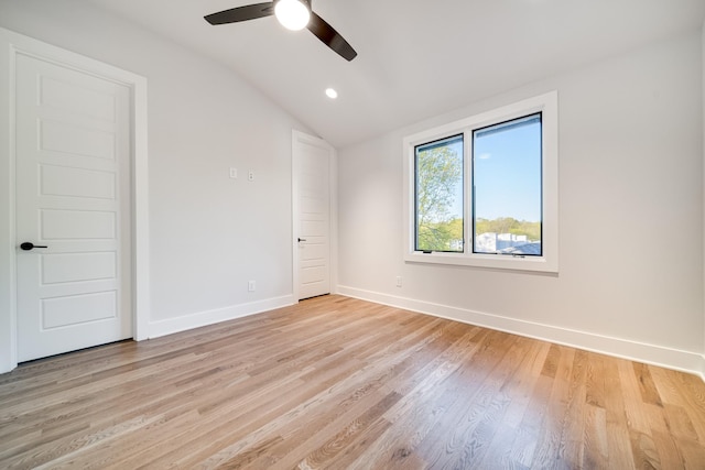 unfurnished room with ceiling fan, light hardwood / wood-style floors, and vaulted ceiling