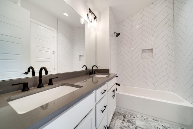 bathroom with vanity and tiled shower / bath combo