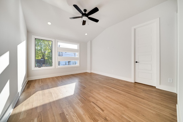 unfurnished room with light wood-type flooring, vaulted ceiling, and ceiling fan