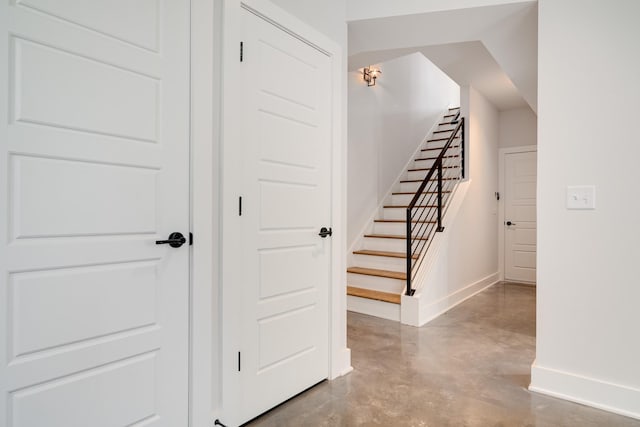 stairs featuring concrete floors