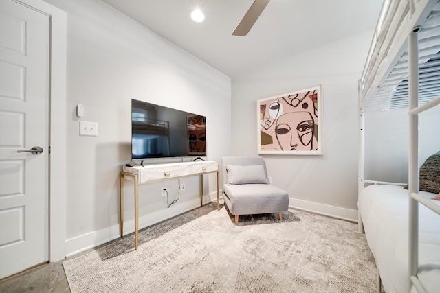 sitting room with ceiling fan and vaulted ceiling