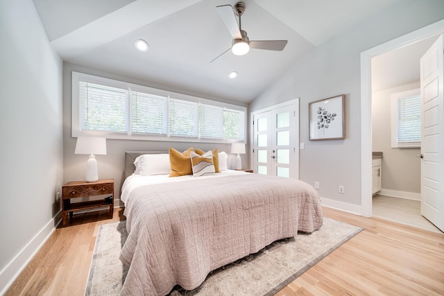 bedroom featuring multiple windows, ceiling fan, light hardwood / wood-style flooring, and vaulted ceiling