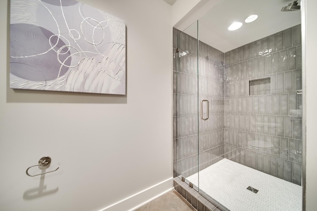 bathroom with tile patterned flooring and an enclosed shower