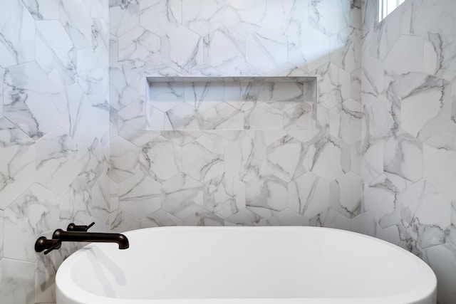 bathroom featuring tile walls and a tub