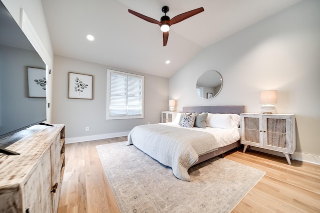 bedroom featuring ceiling fan, light wood-type flooring, and lofted ceiling