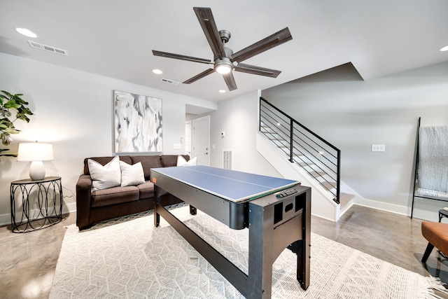 playroom with ceiling fan and concrete floors