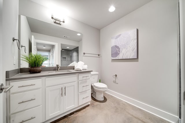 bathroom featuring vanity, a shower, concrete floors, and toilet