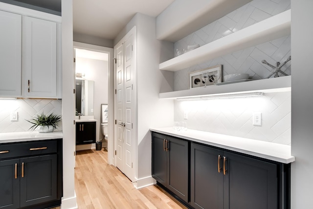 kitchen featuring decorative backsplash and light hardwood / wood-style floors