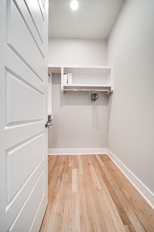 walk in closet featuring light hardwood / wood-style flooring