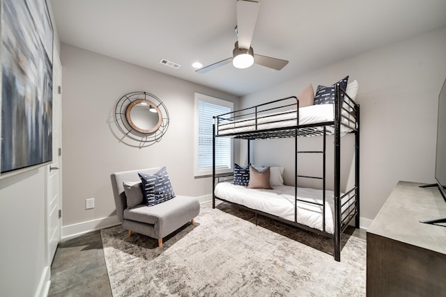 bedroom featuring ceiling fan and concrete floors