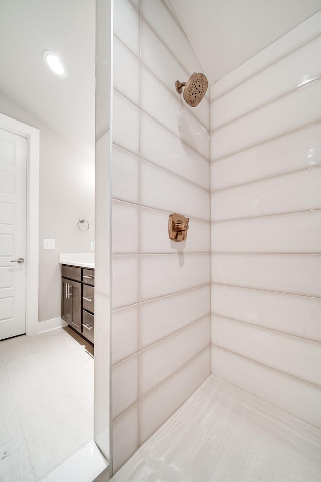 bathroom featuring a shower and vanity