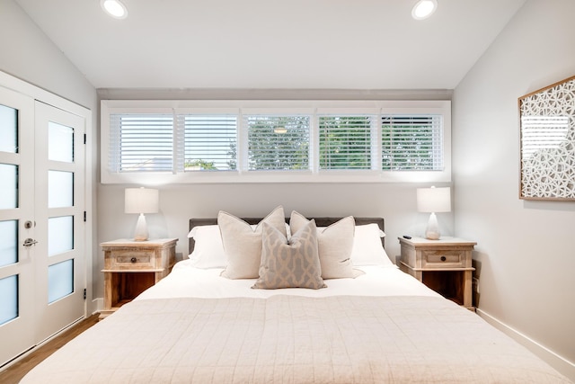 bedroom featuring wood-type flooring and lofted ceiling