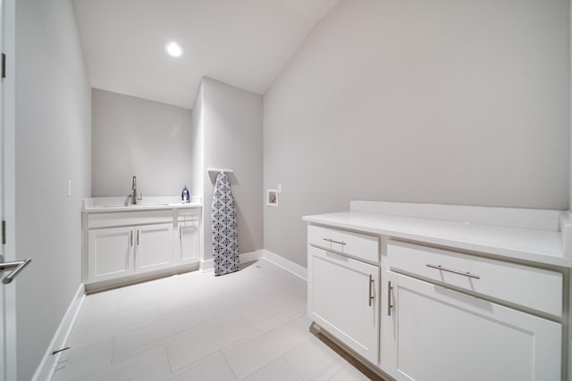 bathroom with sink and vaulted ceiling