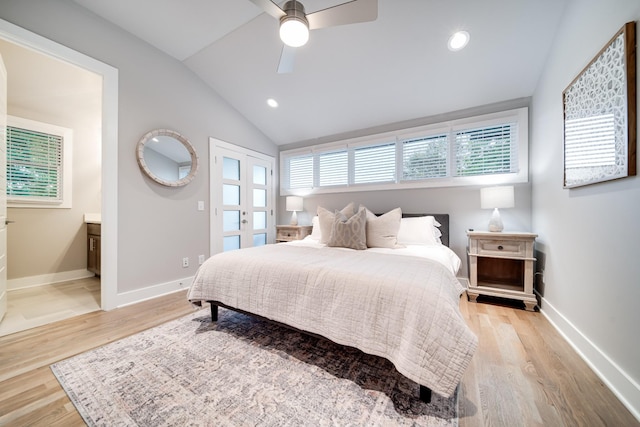 bedroom with ensuite bath, ceiling fan, light hardwood / wood-style floors, and lofted ceiling