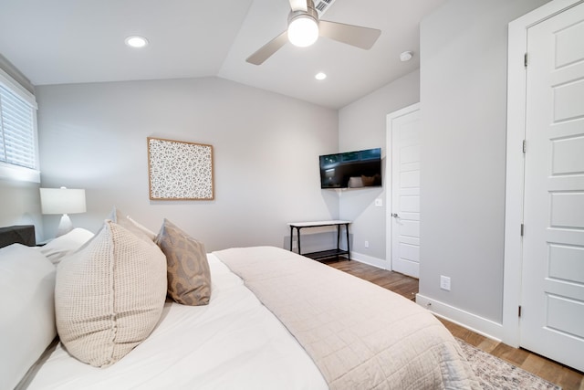 bedroom with hardwood / wood-style flooring, vaulted ceiling, and ceiling fan