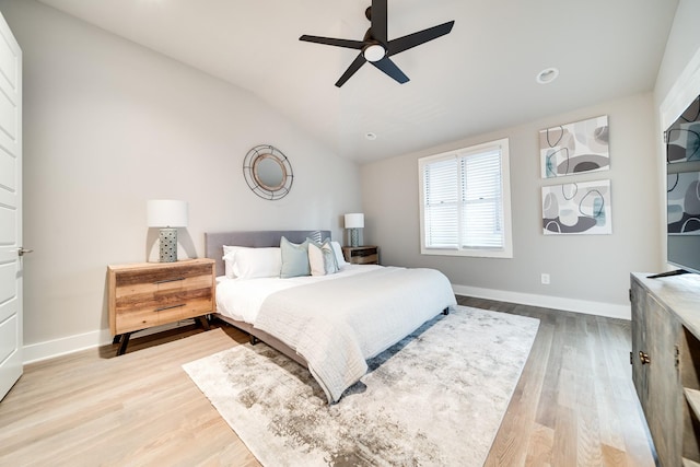 bedroom with ceiling fan, wood-type flooring, and vaulted ceiling