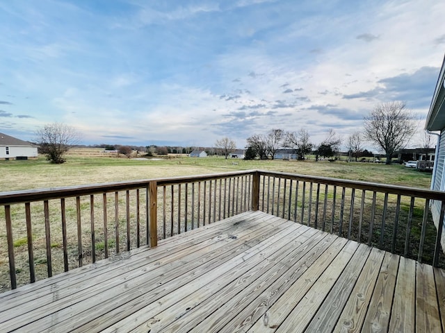 wooden deck featuring a yard