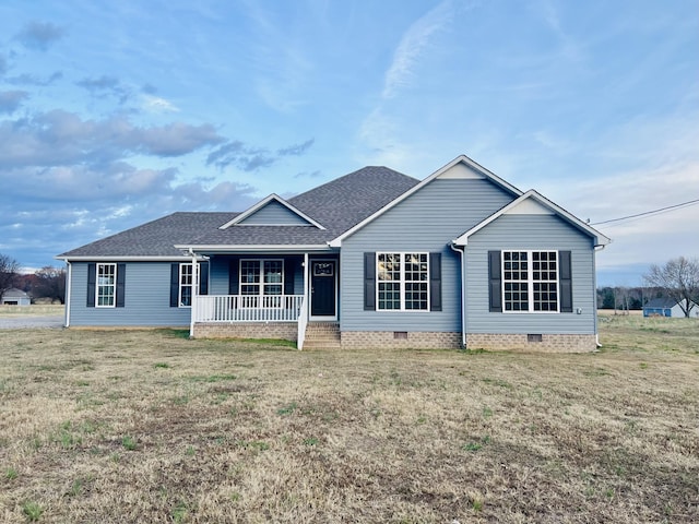 ranch-style home with covered porch and a front lawn