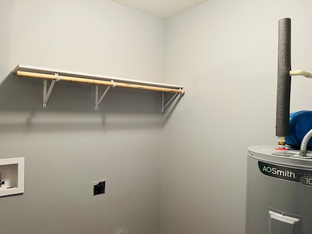 washroom featuring washer hookup, a textured ceiling, electric dryer hookup, and water heater