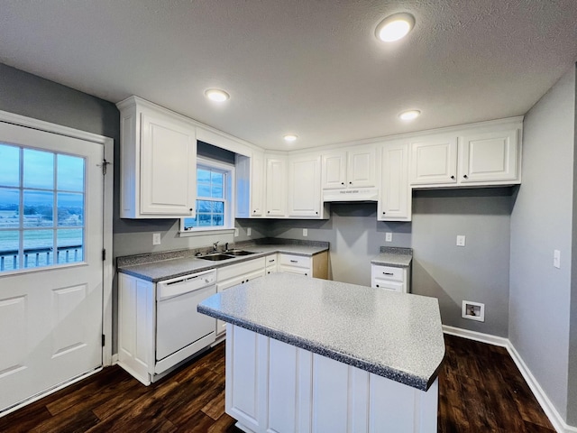 kitchen featuring dishwasher, dark hardwood / wood-style floors, plenty of natural light, and white cabinetry