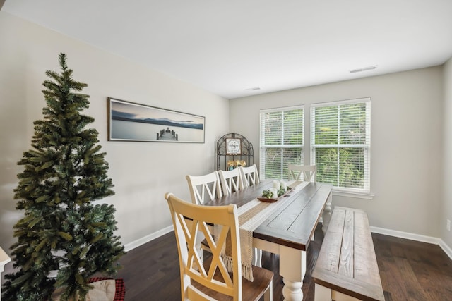 dining space with dark hardwood / wood-style floors