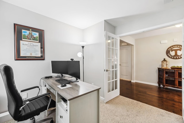 home office with french doors and dark hardwood / wood-style floors