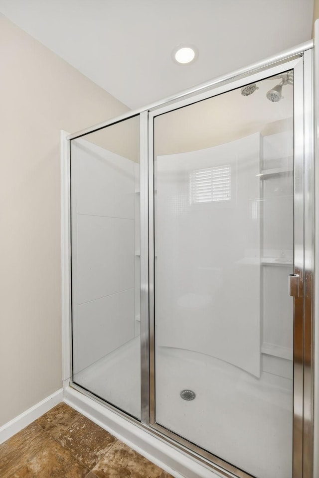 bathroom featuring a shower with door