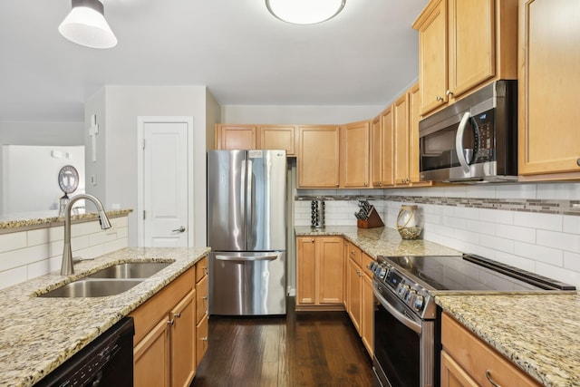 kitchen featuring light stone countertops, appliances with stainless steel finishes, dark hardwood / wood-style floors, and sink