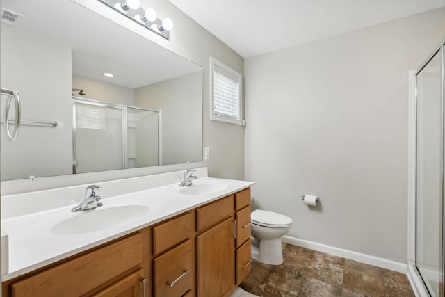 bathroom with vanity, an enclosed shower, and toilet