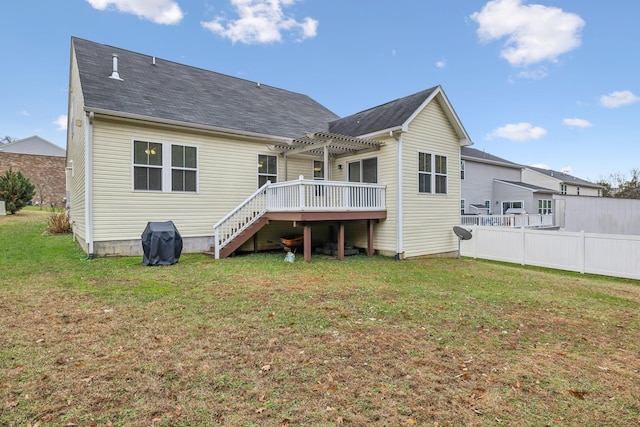 back of property featuring a yard, a pergola, and a deck