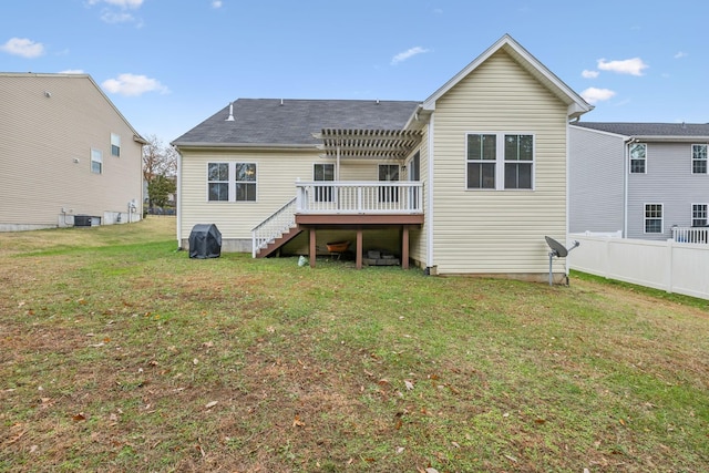 back of property featuring a lawn, central AC unit, a pergola, and a wooden deck