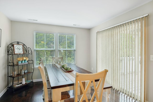 dining space with dark hardwood / wood-style flooring