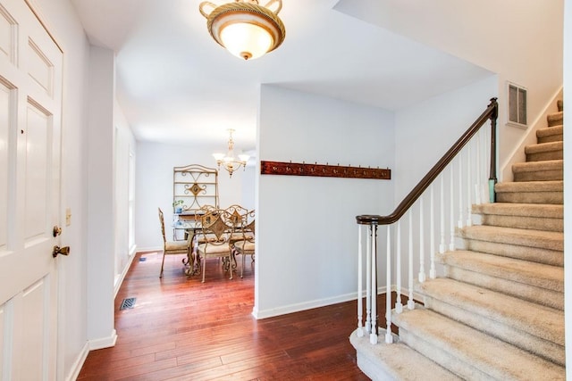 entrance foyer with dark wood-type flooring and a notable chandelier