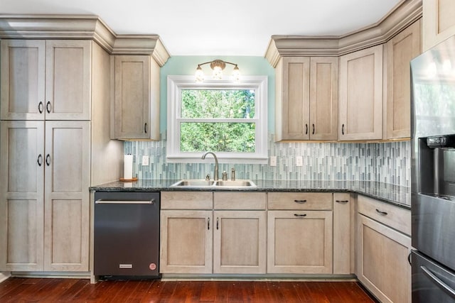 kitchen with dark stone counters, dark hardwood / wood-style flooring, stainless steel appliances, and sink