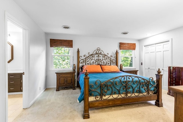 carpeted bedroom featuring a closet and multiple windows