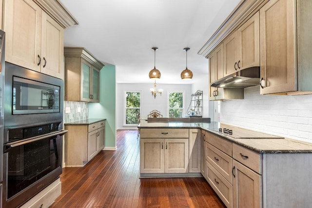 kitchen with dark hardwood / wood-style flooring, backsplash, kitchen peninsula, pendant lighting, and black appliances