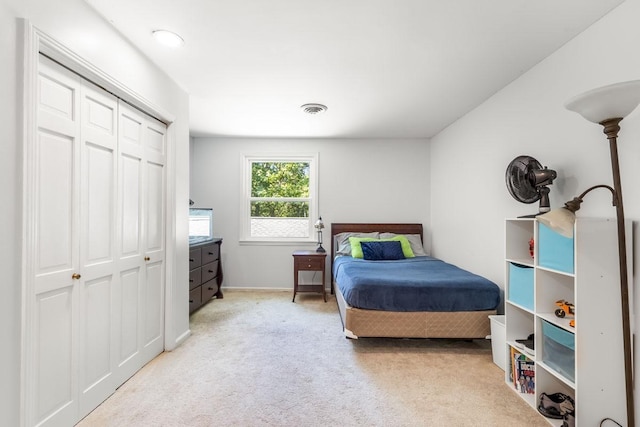 carpeted bedroom with a closet