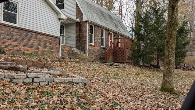 view of side of home featuring a wooden deck