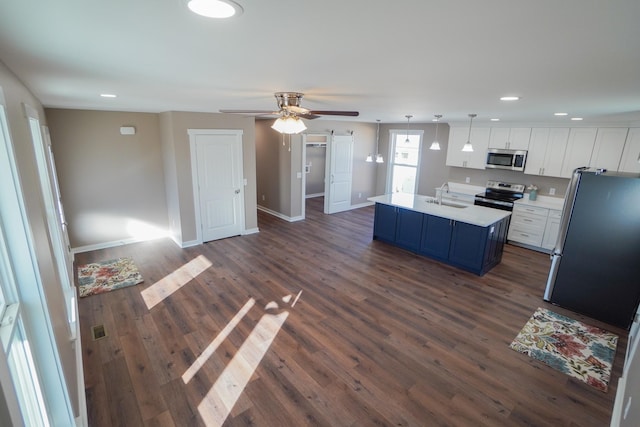 kitchen featuring dark hardwood / wood-style flooring, white cabinetry, sink, and appliances with stainless steel finishes