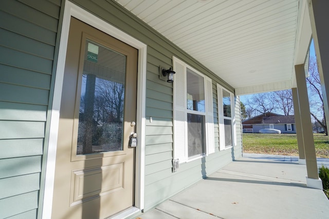 view of exterior entry with a porch