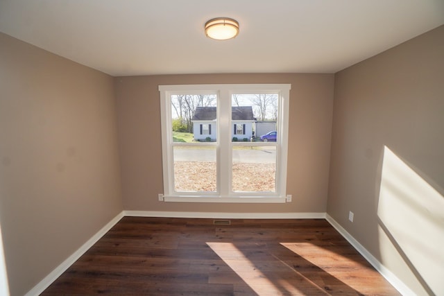 empty room with dark wood-type flooring