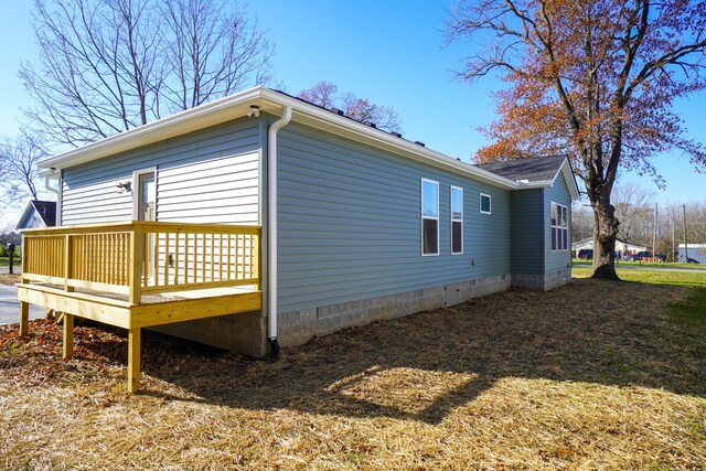 view of property exterior with a wooden deck