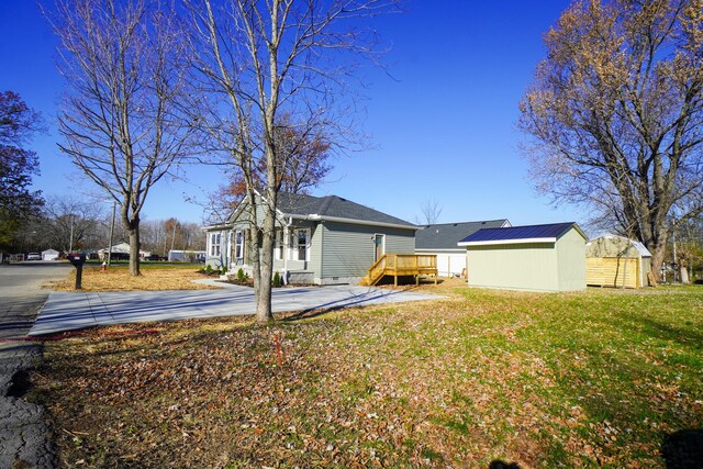 view of yard with a shed and a deck