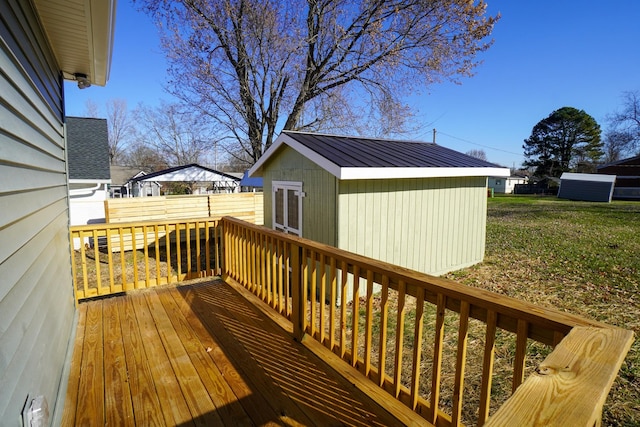 wooden terrace with a storage unit and a yard