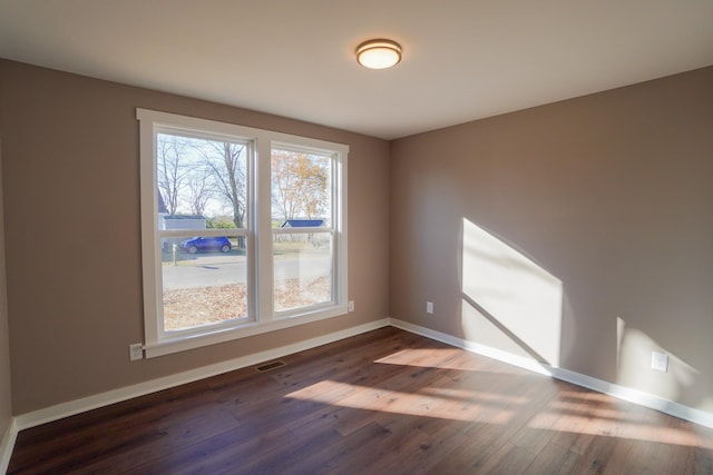 spare room featuring dark hardwood / wood-style floors