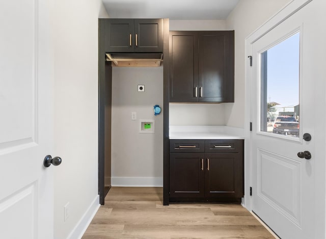 kitchen with dark brown cabinets and light hardwood / wood-style floors