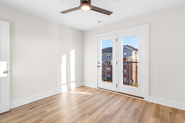 empty room with ceiling fan and light wood-type flooring