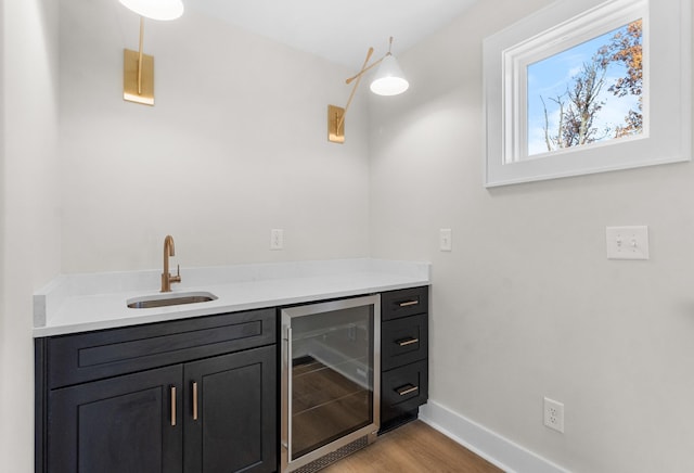 bathroom with hardwood / wood-style floors, vanity, and beverage cooler