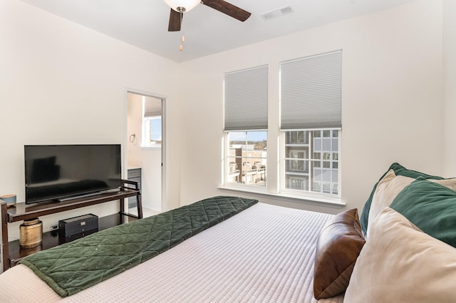 bedroom featuring connected bathroom and ceiling fan